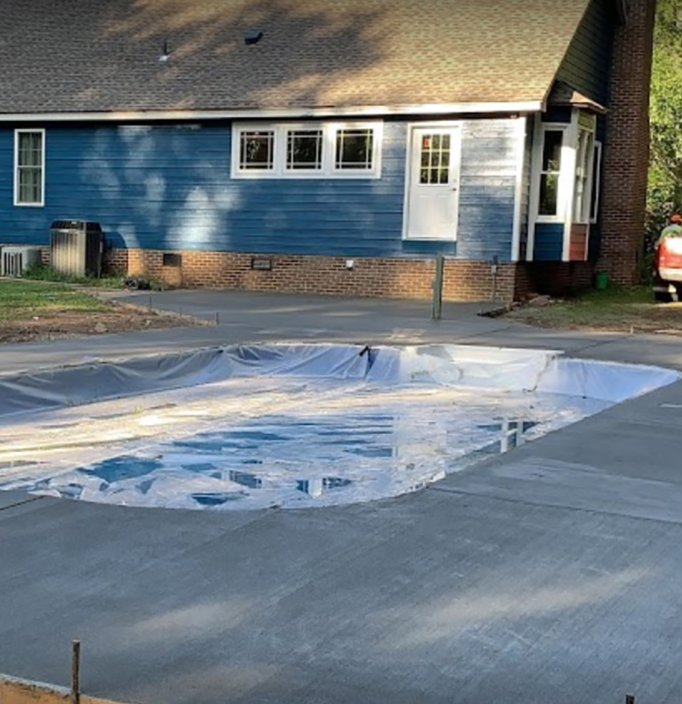 New concrete pad laid around a pool